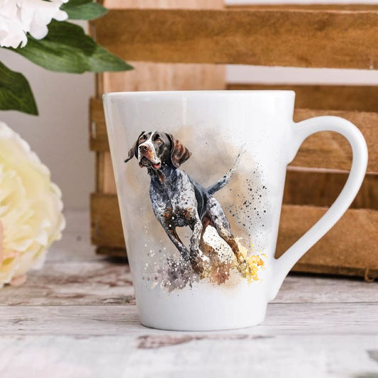 A 12oz white ceramic latte mug with a printed image of an English Pointer running, Image has a blurred background.  Mug is positioned on a wooden surface.