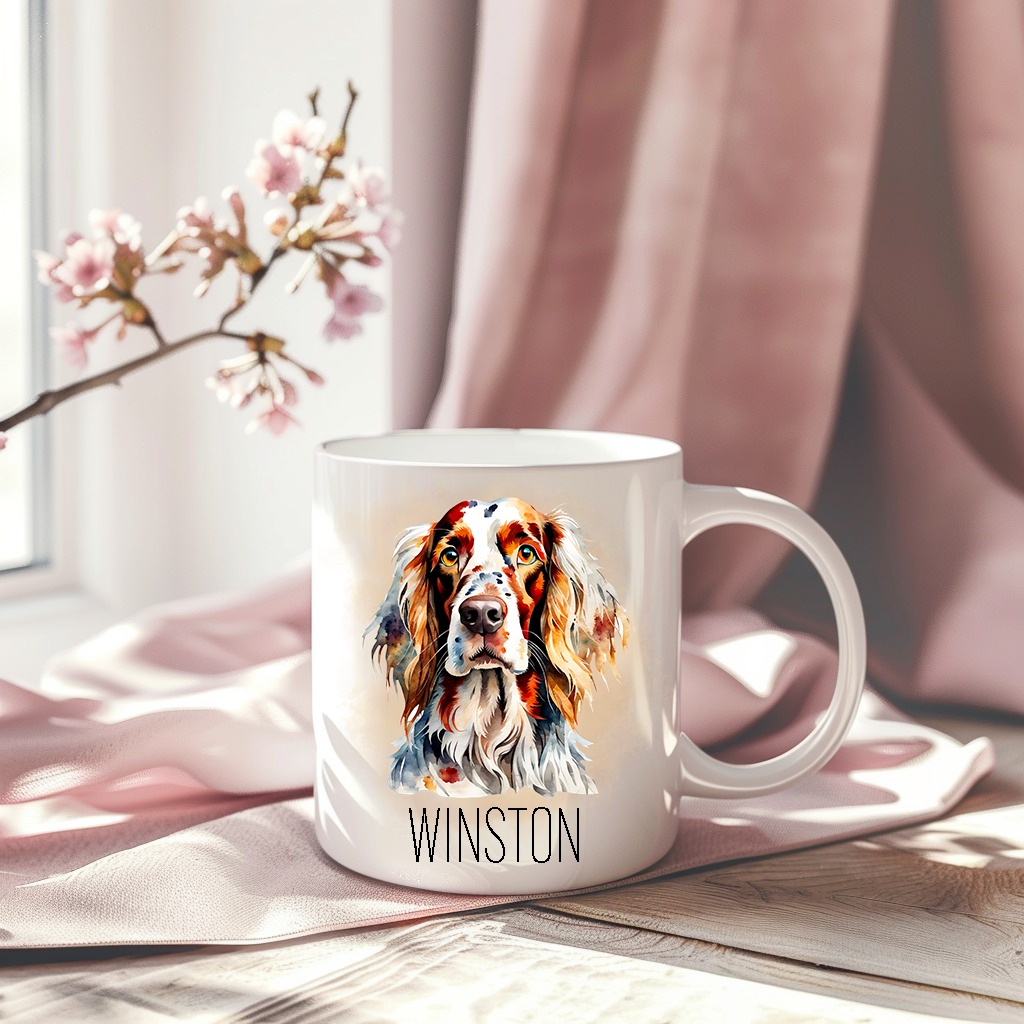 English Setter headshot on a white ceramic mug which has been placed on a pink drape.  A stem of small pink flowers accessorizes the image.  The mug is personalised.
