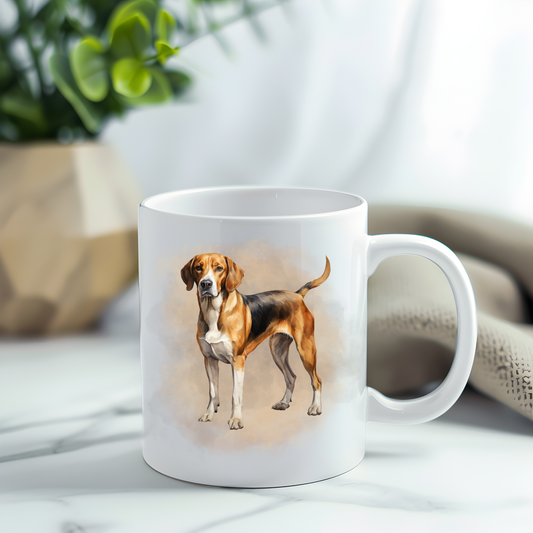 A Foxhound in a standing position on a white ceramic mug which has been placed on a grey marble surface.  A plant decorates the left corner. 