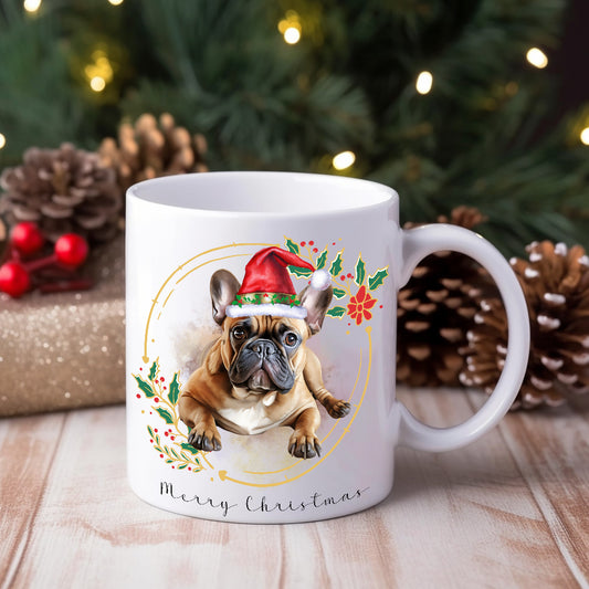 French Bulldogin a lying position wearing a Santa hat on a Christmas themed mug.  Lights, pine cones and gifts decorate the background.