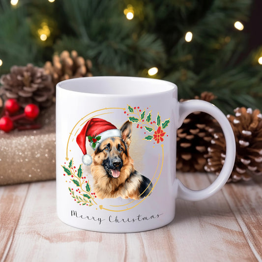 White ceramic mug featuring a German Shepherd dog wearing a Santa hat.  Pine cones and gifts decorate the background.
