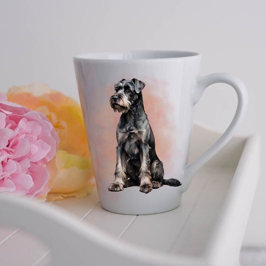 A Giant Schnauzer dog is seen sitting on a white ceramic latte mug in a smoky background and looking forward.  The mug is placed on a white tray with pink and yellow flowers. 