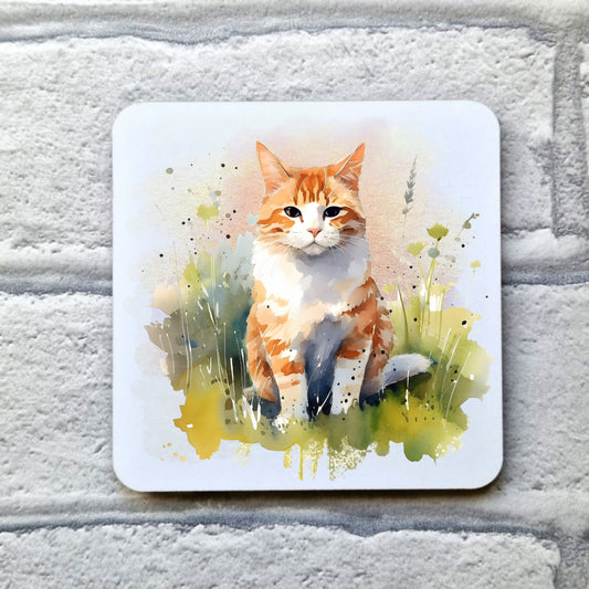 Ginger and white cat sat on grass on a white coaster. Coaster is placed on a grey brick background