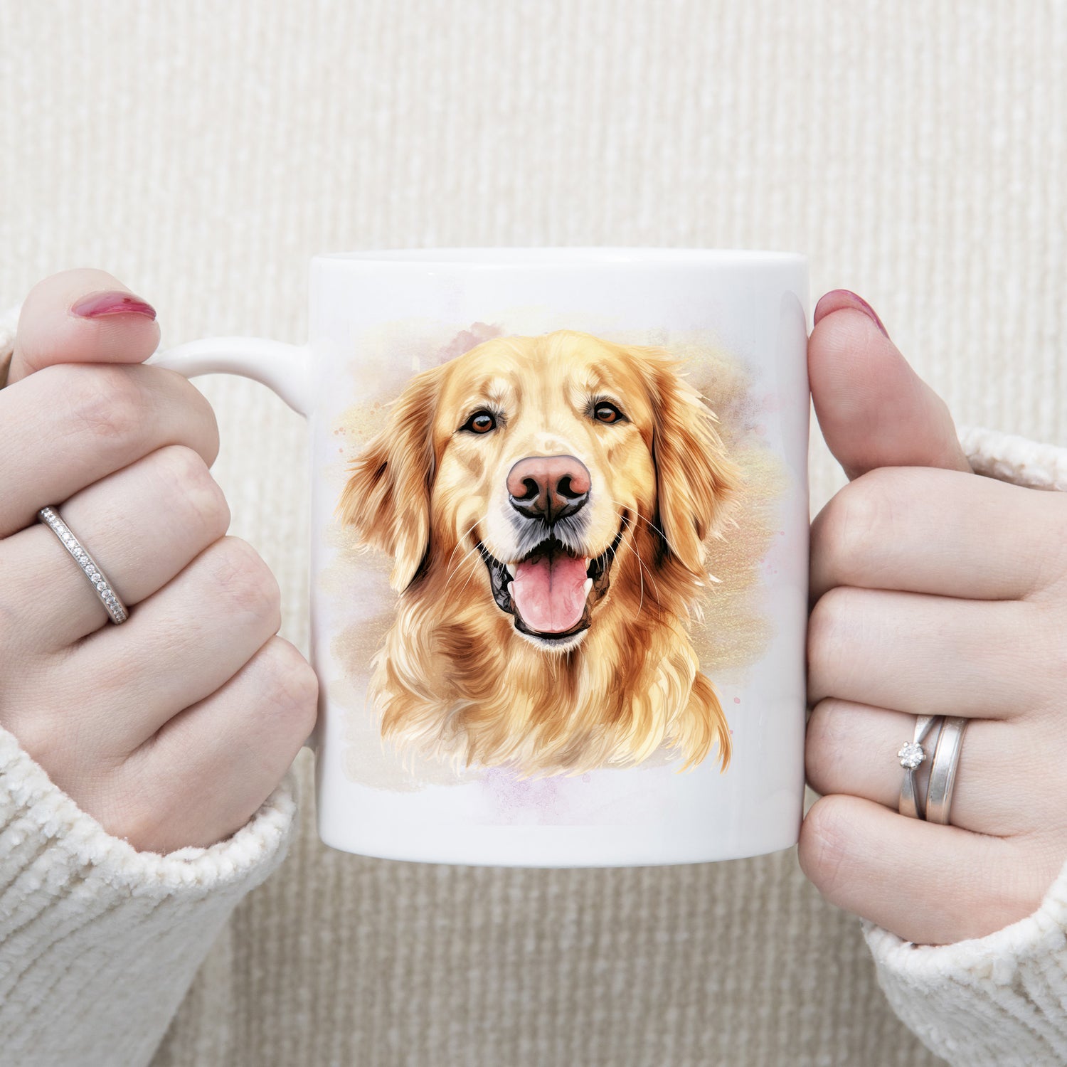 A head shot of a Golden Retriever dog facing forward, mouth open and looking happy.  A woman is holding the mug in two hands.