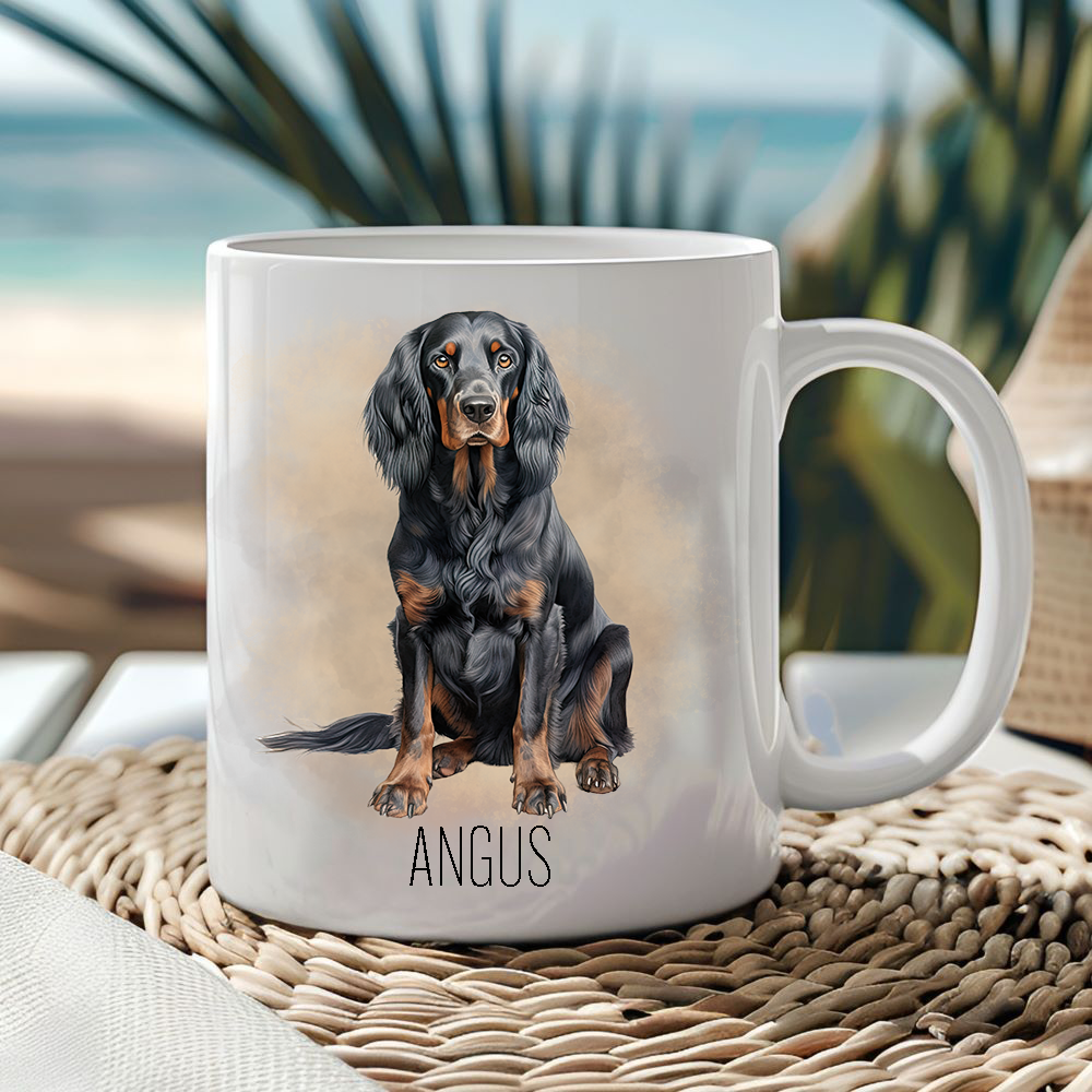 White ceramic mug showing a Gordon Setter in a sitting position with a gold/brown smoke effect background.  Mug is placed on a wicker mat  with an ocean scene in the background.