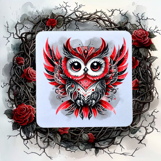 White coaster showing a Gothic Owl with red and black feathers on a smoky grey background. The coaster is placed on a background of thorns and roses.