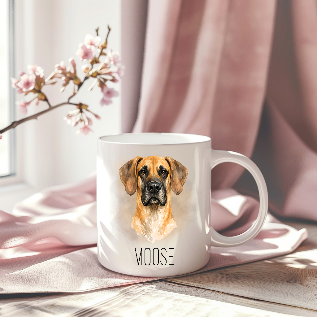 Great Dane headshot on a white ceramic mug which has been placed on a pink drape.  A stem of small pink flowers accessorizes the image.