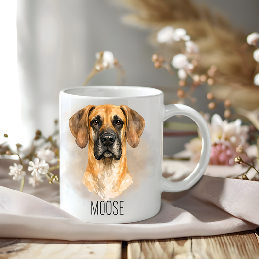 Great Dane coffee mug personalised with a pet name.  The mug is sat on a wooden surface with a creamy coloured cloth and various flowers adorn the background.
