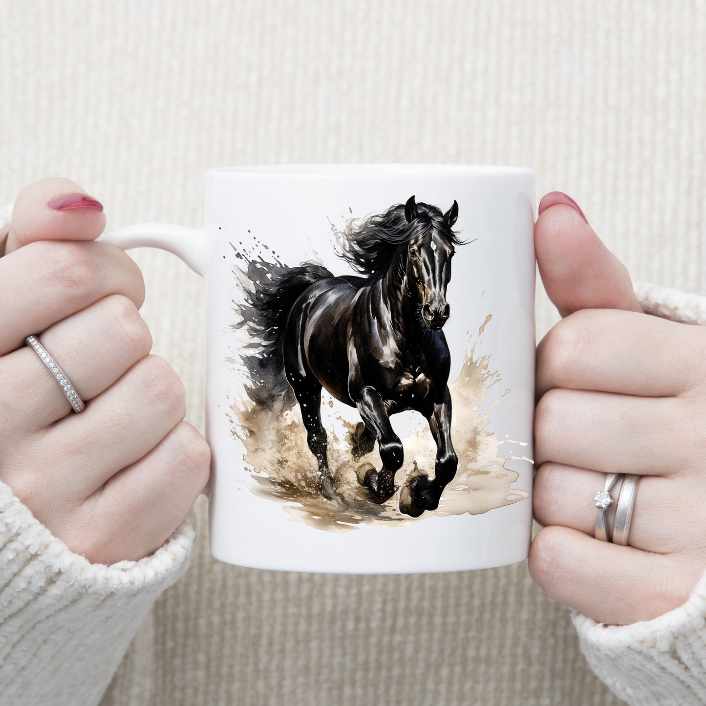 Black stallion horse running through muddy water.  Image on a white ceramic mug being held with both hands by a woman.