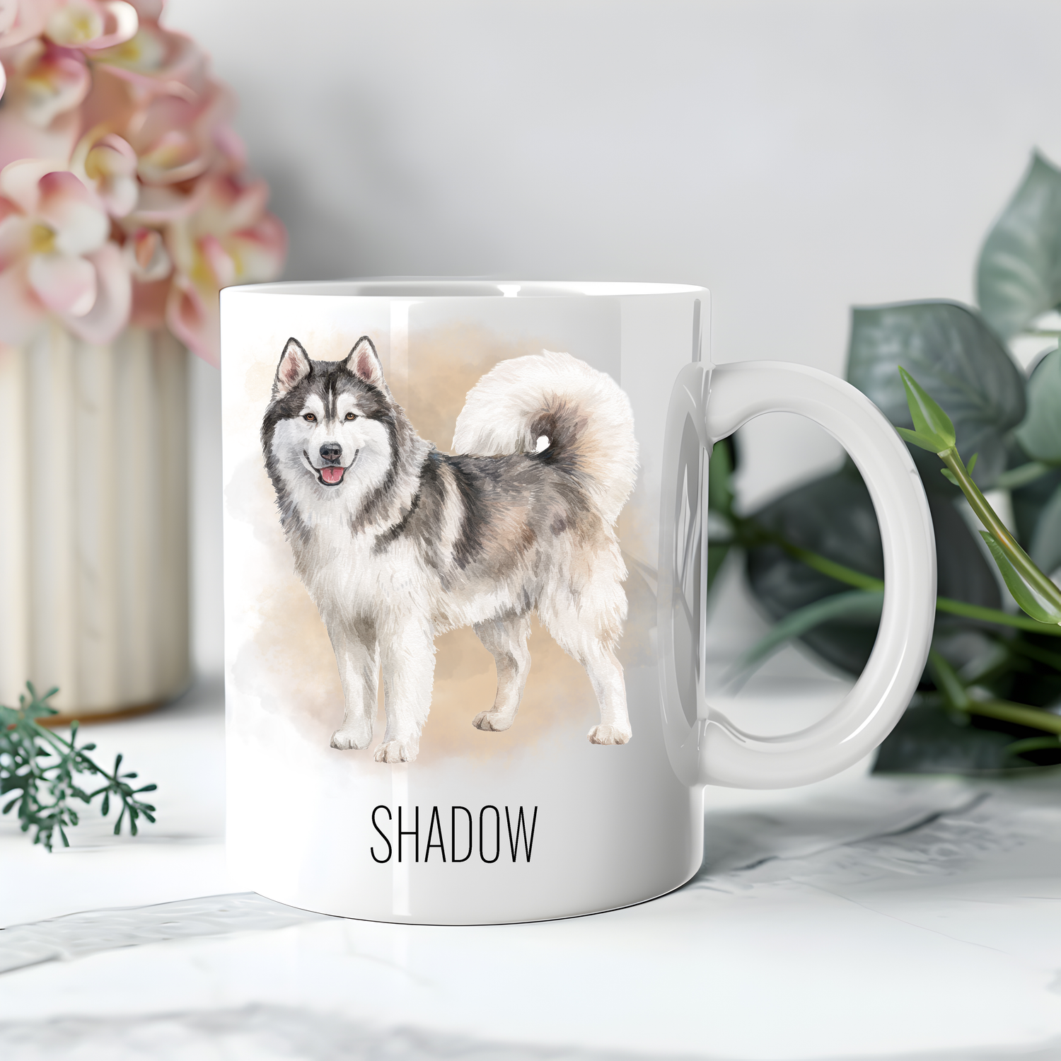 Personalised coffee mug featuring a Husky on a white ceramic mug which has been placed on a beige cloth.  A large pink flower with green foliage accessorizes the image.