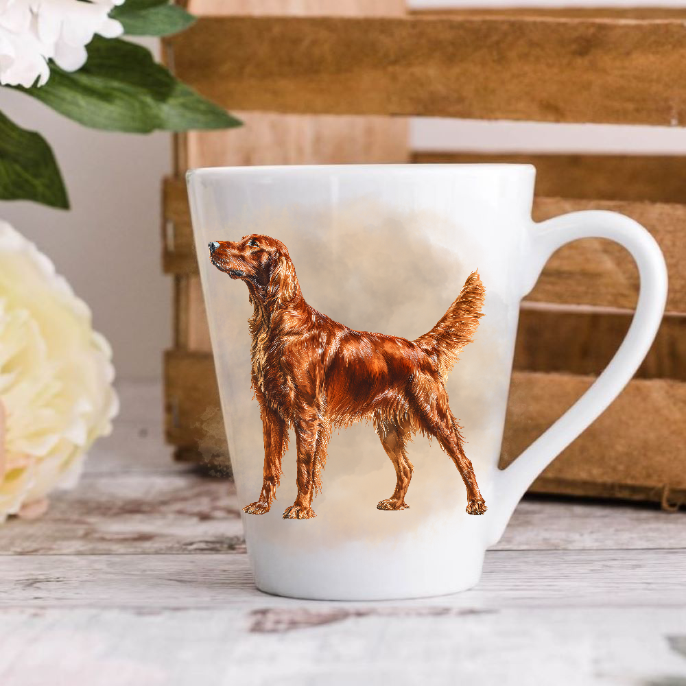 A white ceramic latte mug stands on a wooden surface with a crate in the background. The mug features an Irish Setter.  A large yellow flower peeps in from the left-hand side.