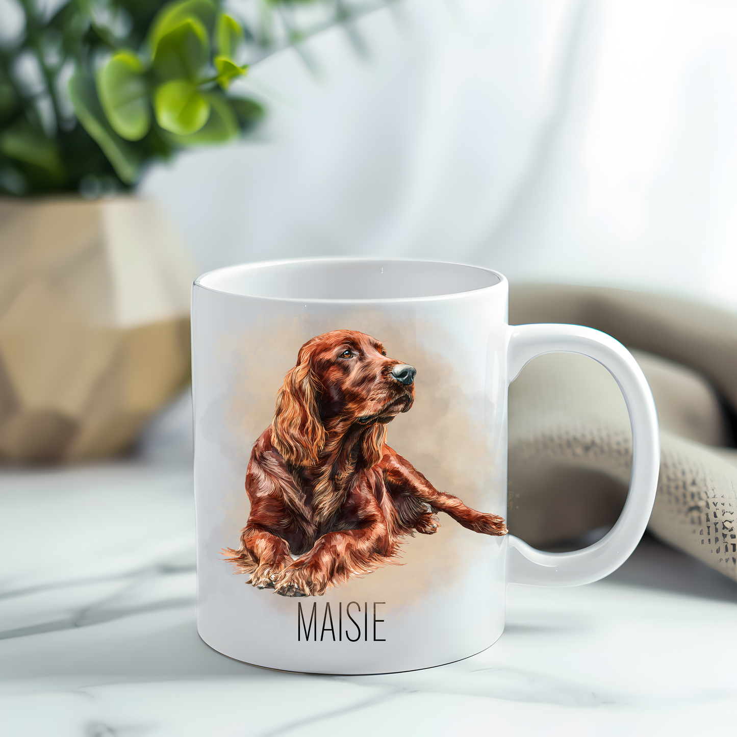 This coffee mug features an Irish Setter on a white ceramic mug which has been placed on a grey marble surface.  A green plant sits in the left corner.