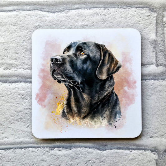 A White drinks coaster with a head shot of a Black Labrador looking left with a pink and gold misty background. The coaster is placed on a grey, brick effect surface.