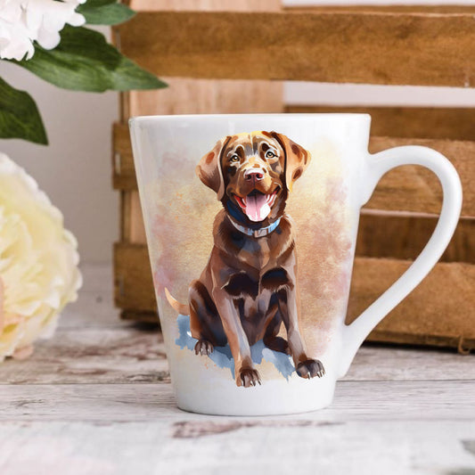 A 12oz white ceramic latte mug with a printed image of a chocolate Labrador dog, positioned on a wooden surface with a blurred background.