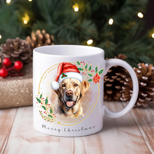 A ceramic mug with a watercolor design of a Labrador wearing a Santa hat, surrounded by Christmas decorations, placed on a festive table with pine cones and lights in the background.