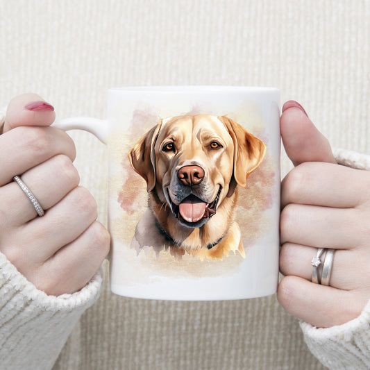 A Yellow Labrador dog with a amber eyes and a tongue out adorns this white ceramic mug.  A pink and gold misty background decorates the mug which is being held by a woman with both hands.