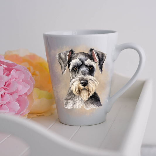 A Miniature Schnauzer dog is seen on a white ceramic latte mug in a smoky background and looking forward.  The mug is placed on a white tray with pink and yellow flowers. 