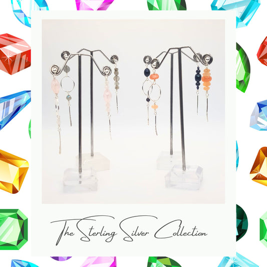 A photo of a pair of asymmetric drop earrings with sterling silver posts. One earring has a multi-shape gemstone design, and the other features a circular hoop design in the center.