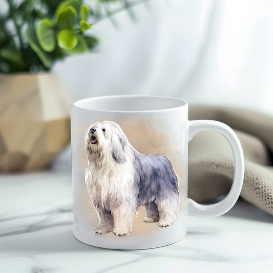 This coffee mug features an Old English Sheepdog on a white ceramic mug which has been placed on a grey marble surface.  A green plant sits in the left corner.