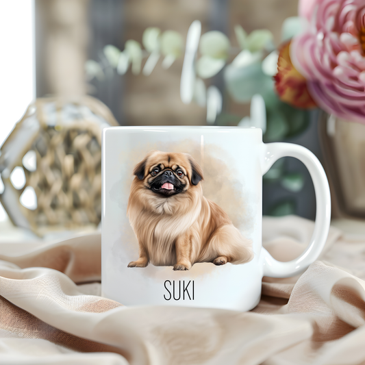 A Pekingese dog is sat looking forward  on a white personalised ceramic mug which has been placed on a beige cloth.  A large pink flower with green foliage accessorizes the image.
