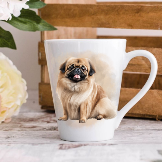 A white ceramic latte mug stands on a wooden surface with a crate in the background. The mug features a Pekingese dog. A large yellow flower peeps in from the left-hand side.