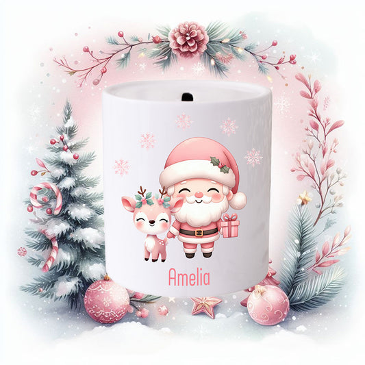 Personalised Christmas money box for a girl.  Santa dressed in pink and holding a gift.  A cute reindeer stands to the left. Christmas detail in the background.