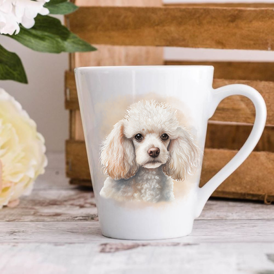 A white ceramic latte mug stands on a wooden surface with a crate in the background. The mug features a White Miniature Poodle. A large yellow flower peeps in from the left-hand side.
