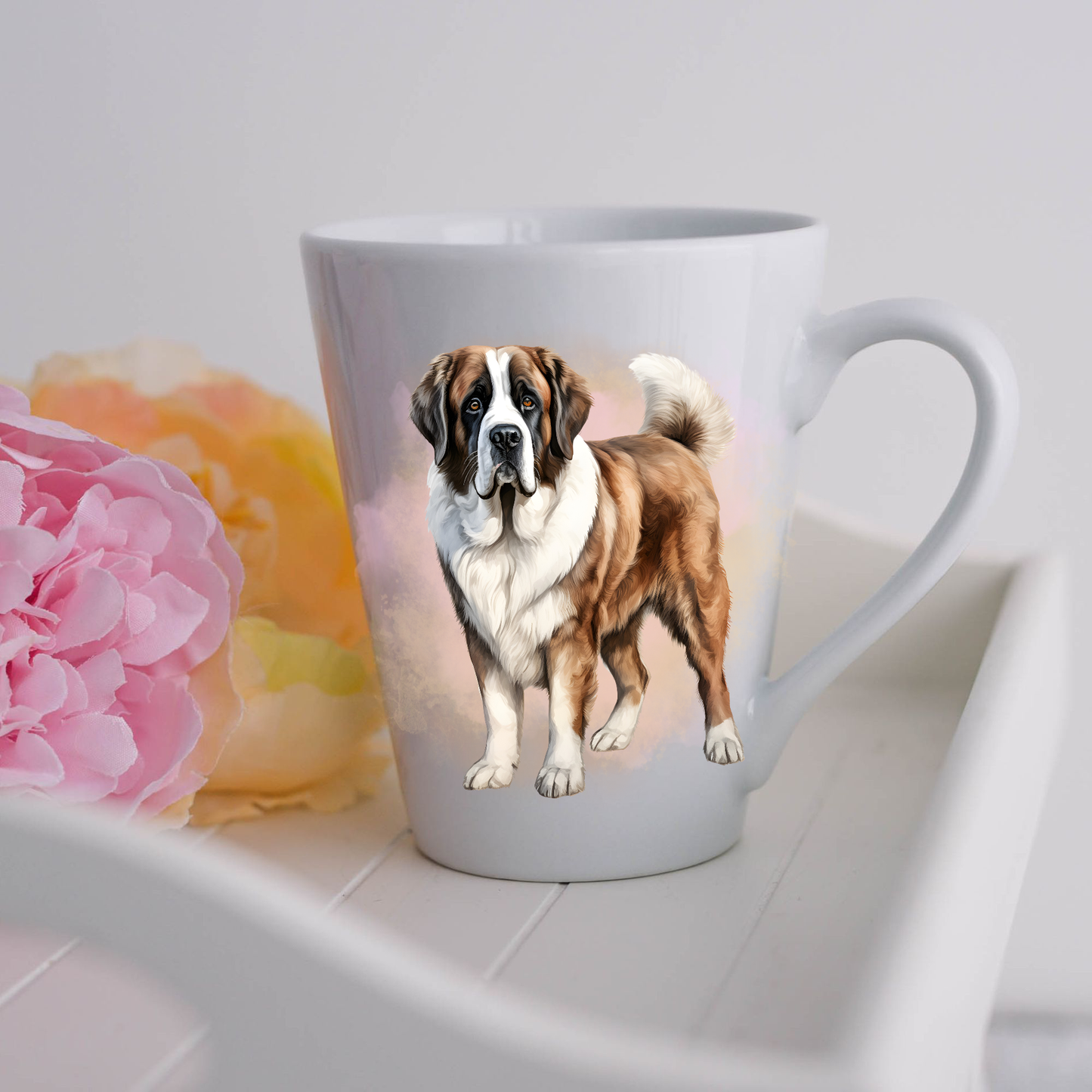 A Saint Bernard dog is seen standing on a white ceramic latte mug in a smoky background and looking forward.  The mug is placed on a white tray with pink and yellow flowers