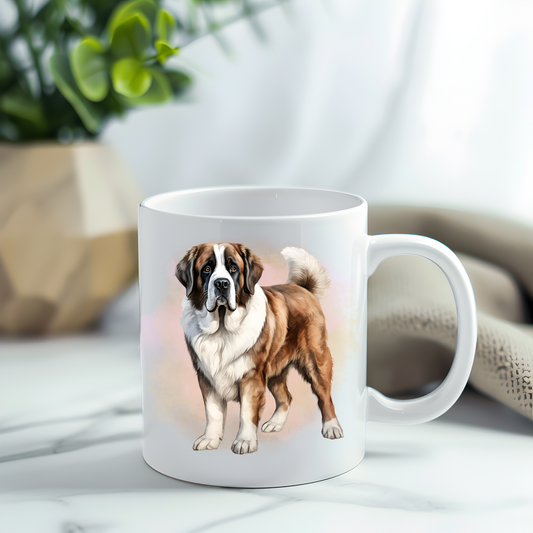 This coffee mug features a lovely, cuddly Saint Bernard on a white ceramic mug which has been placed on a grey marble surface.  A green plant sits in the left corner.