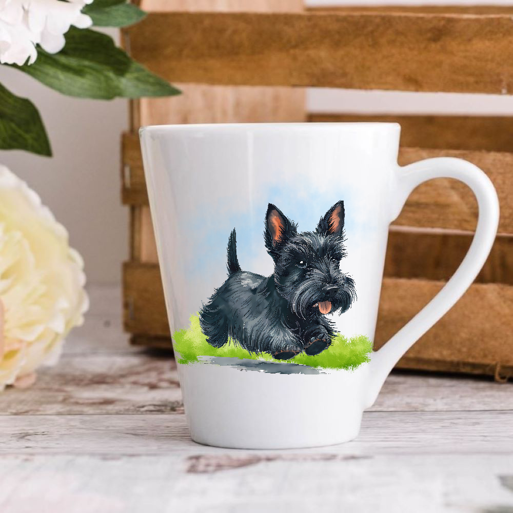 A white ceramic latte mug stands on a wooden surface with a crate in the background. The mug features a black Scottish Terrier running on a grassy surface.  A large yellow flower peeps in from the left-hand side.