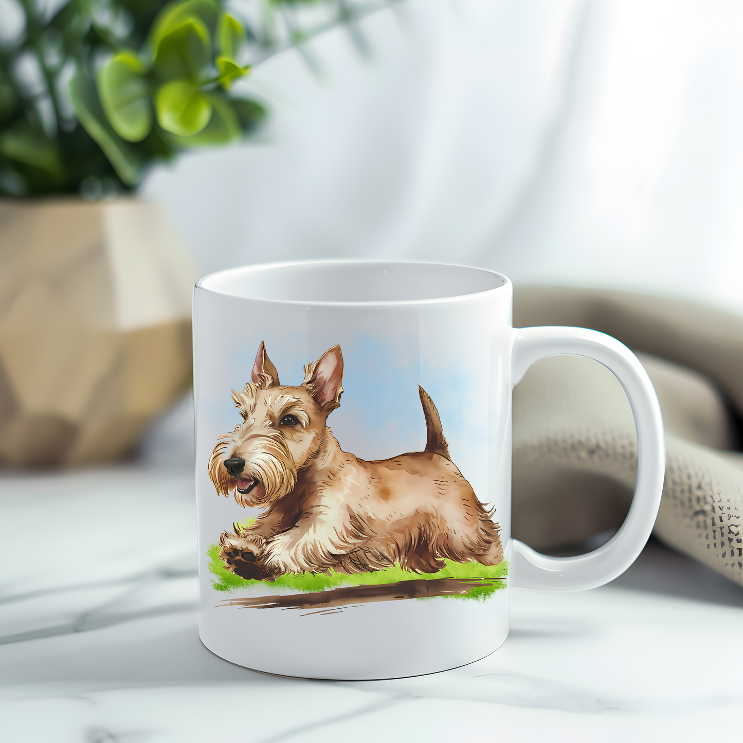 This coffee mug features a wheaten Scottish Terrier on a white ceramic mug which has been placed on a grey marble surface.  A green plant sits in the left corner.