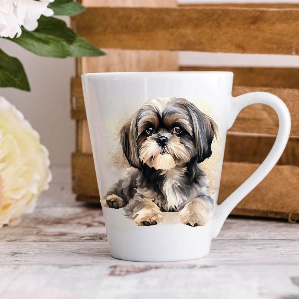 A white ceramic latte mug stands on a wooden surface with a crate in the background. The mug features a Shih Tzu dog.  A large yellow flower peeps in from the left-hand side.