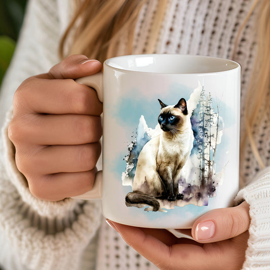 hand held white mug featuring a sitting siamese cat with a blue background and trees to the side.