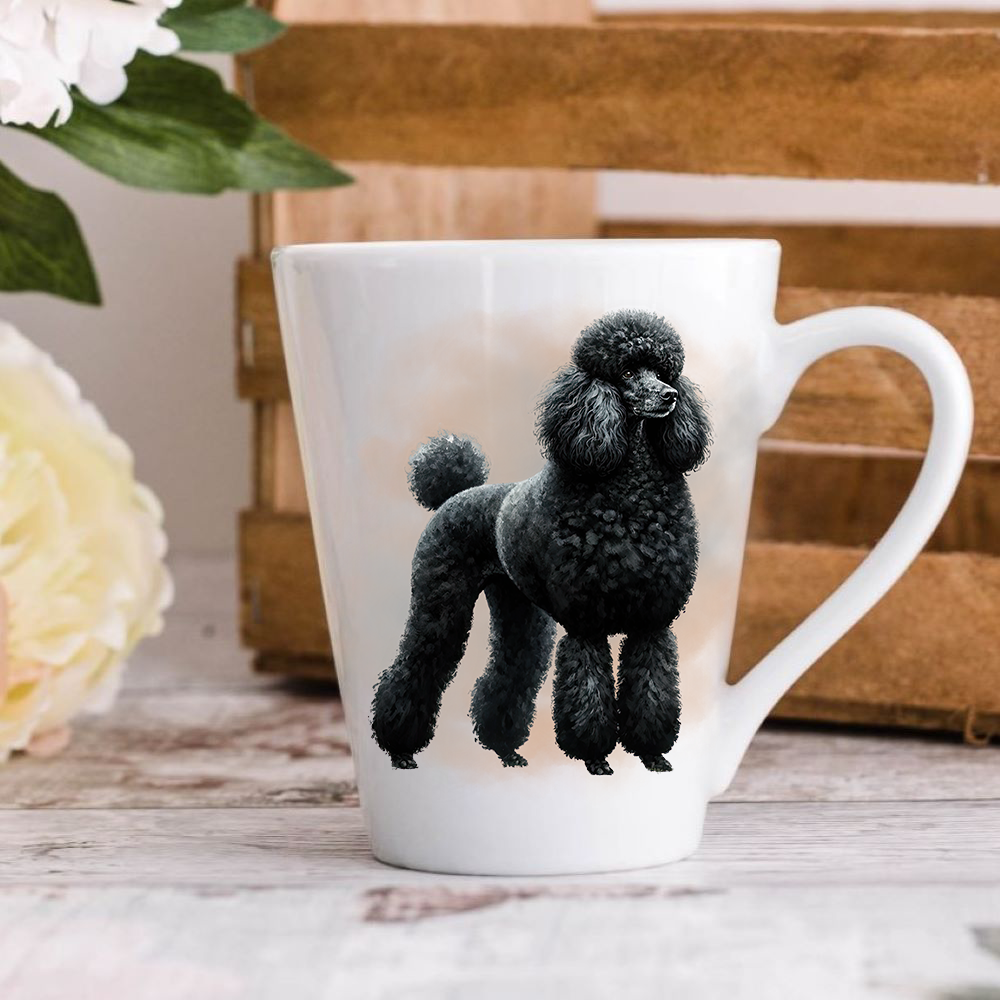 A white ceramic latte mug stands on a wooden surface with a wood crate in the background. The mug features a black Standard Poodle.  A large yellow flower peeps in from the left-hand side.
