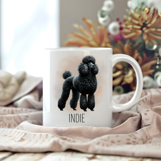 Personalised coffee mug featuring a black Standard Poodle on a white ceramic mug which has been placed on a beige cloth. Stems of large flowers accessorizes the image