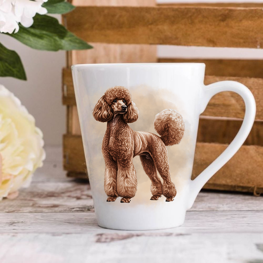 A white ceramic latte mug stands on a wooden surface with a wood crate in the background. The mug features a brown Standard Poodle.  A large yellow flower peeps in from the left-hand side.