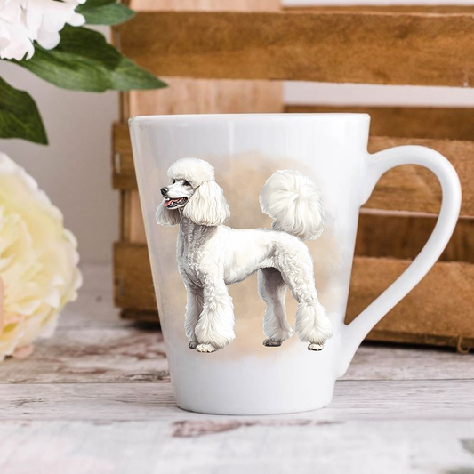 A white ceramic latte mug stands on a wooden surface with a wood crate in the background. The mug features a white Standard Poodle.  A large yellow flower peeps in from the left-hand side.