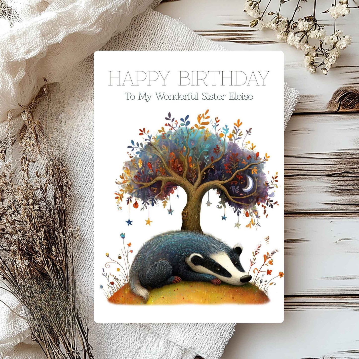 Birthday card with a badger and tree design on a textured surface with flowers.