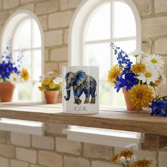 Ceramic mug with an elephant design on a windowsill with flowers