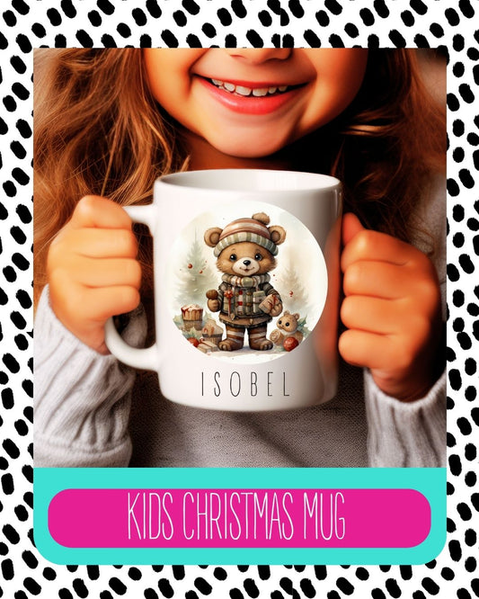 A child holding a white ceramic mug with a cartoon bear design and the text 'Kids Christmas Mug'.