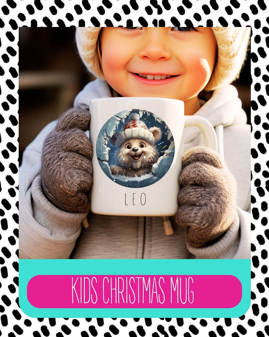 A child holding a white ceramic mug with a cartoon bear design and the text 'Kids Christmas Mug' on a polka-dotted background.