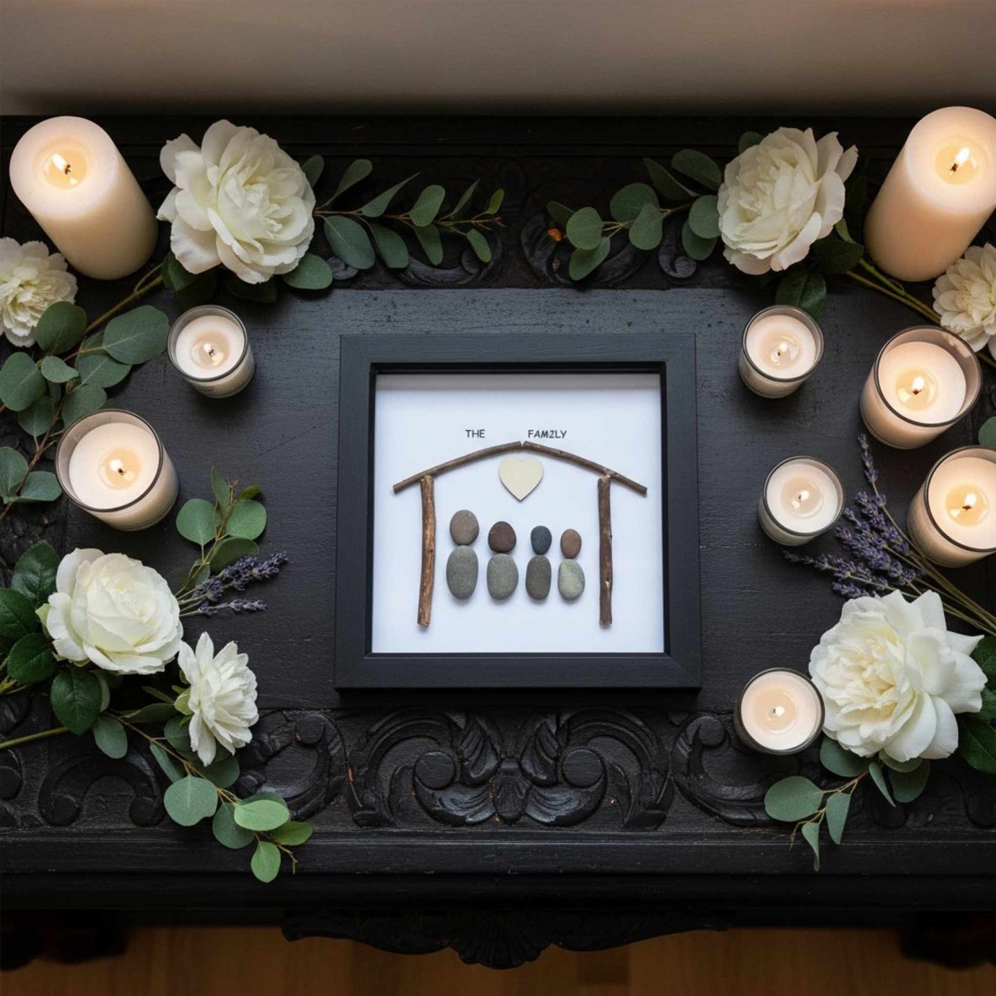 Decorative setup with candles, flowers, and a framed family portrait on a dark surface.
