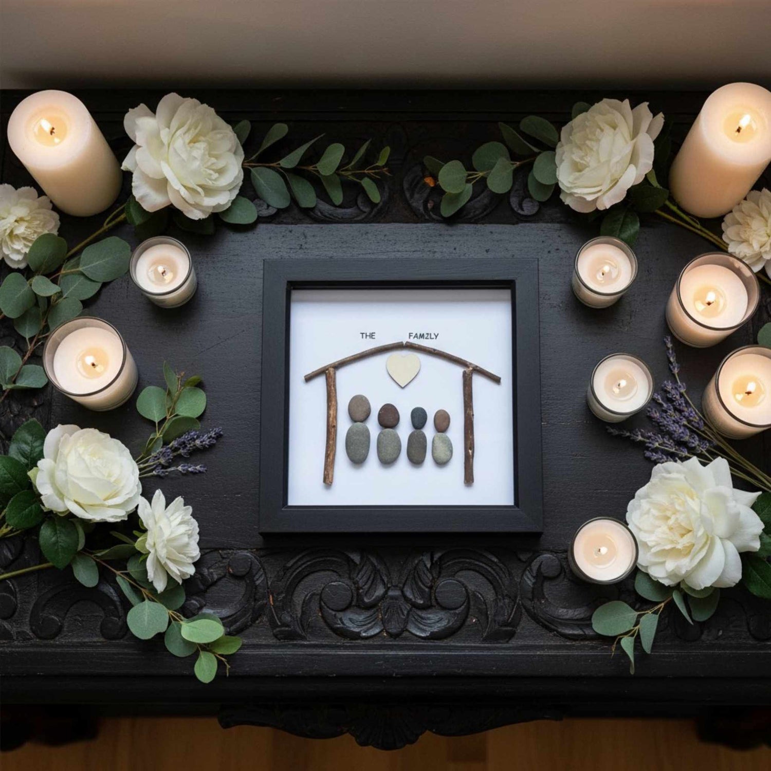 Decorative setup with candles, flowers, and a framed family portrait on a dark surface.