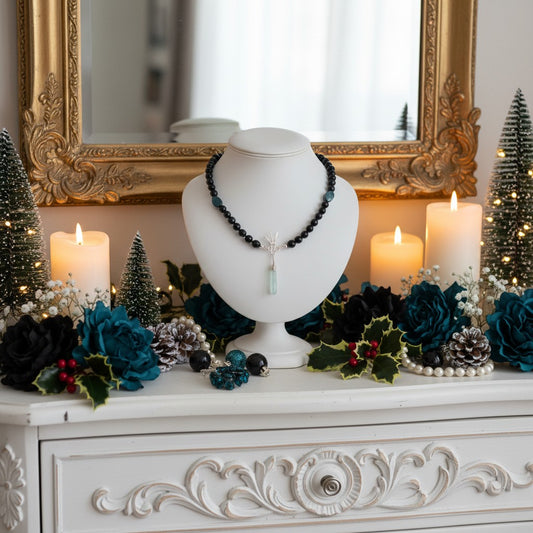 Blue gemstone necklace in a festive staged theme with candles and Christmas elements.
