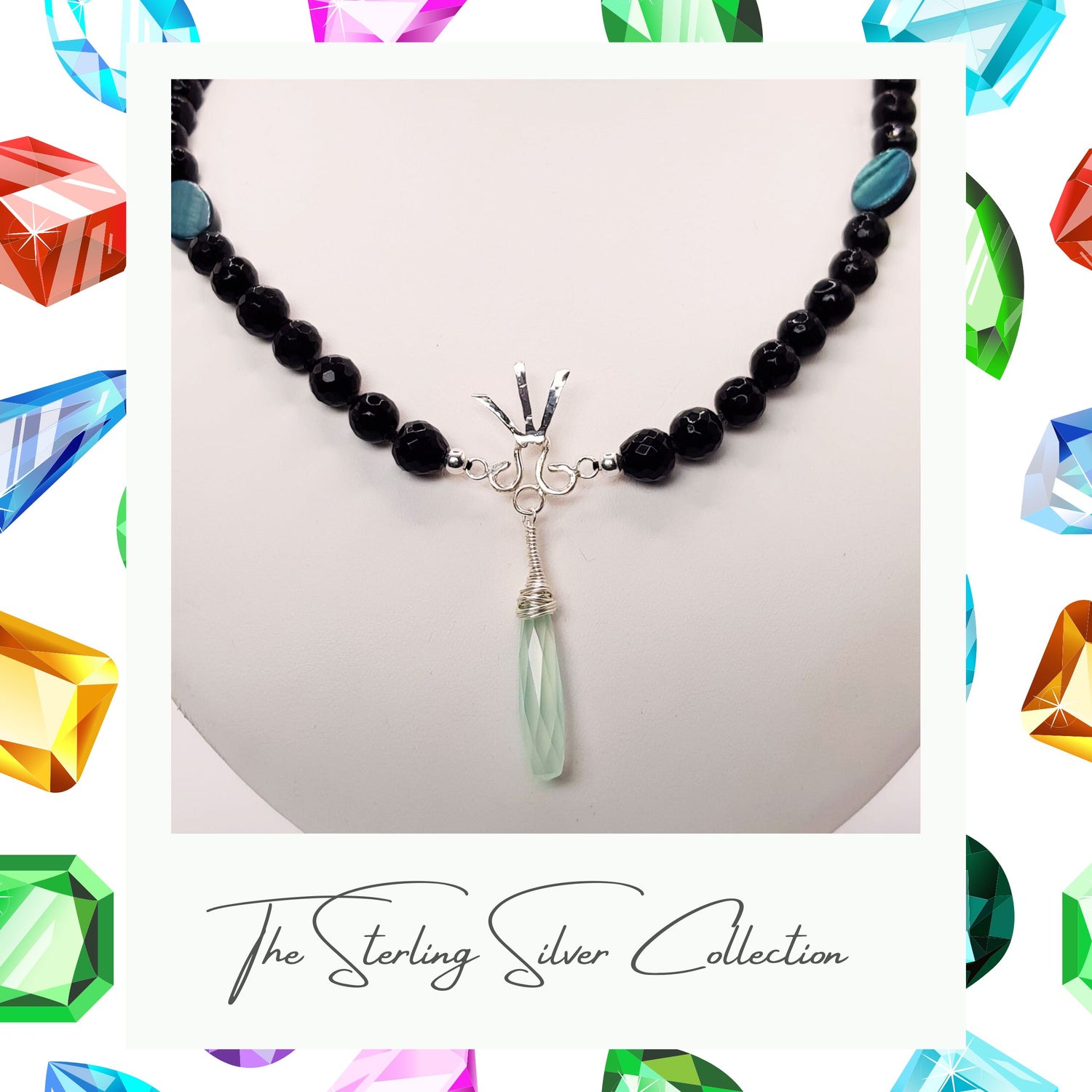 A blue agate necklace with spear design and sterling silver elements close up.