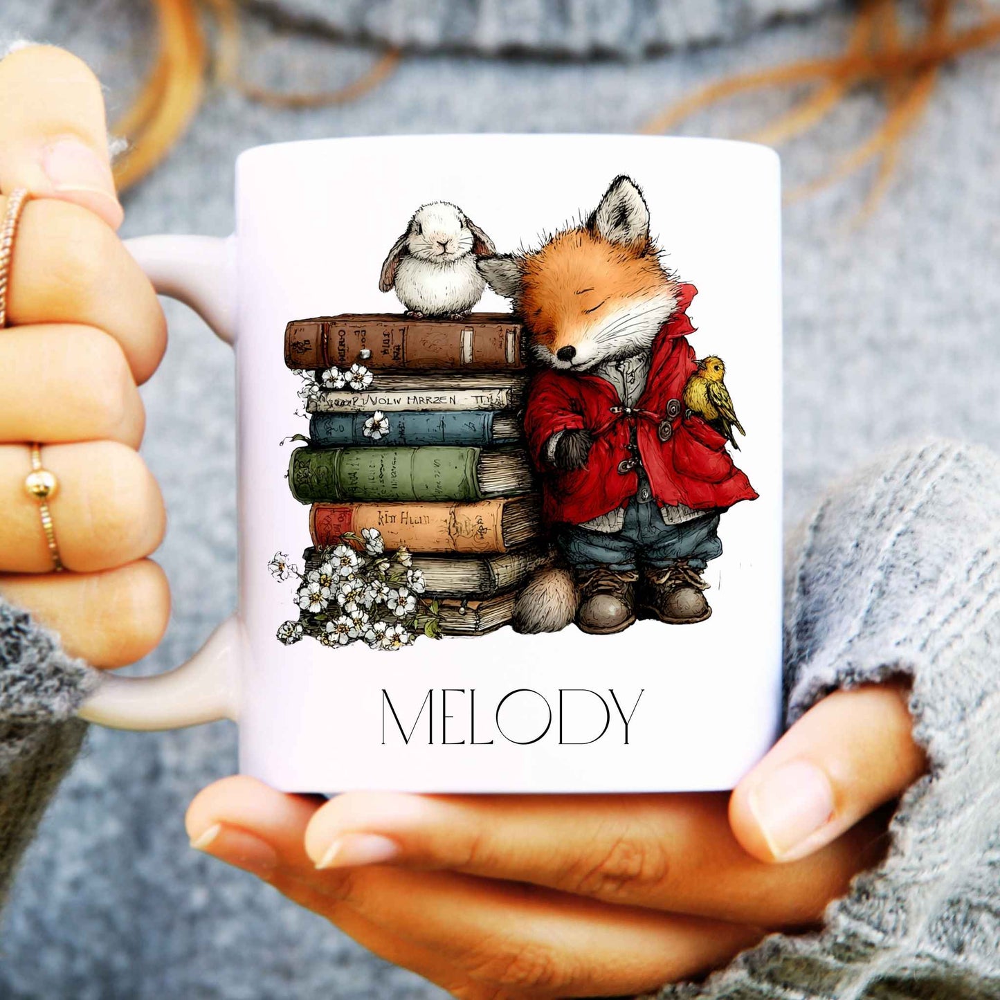 Mug with a fox and books design held by hands