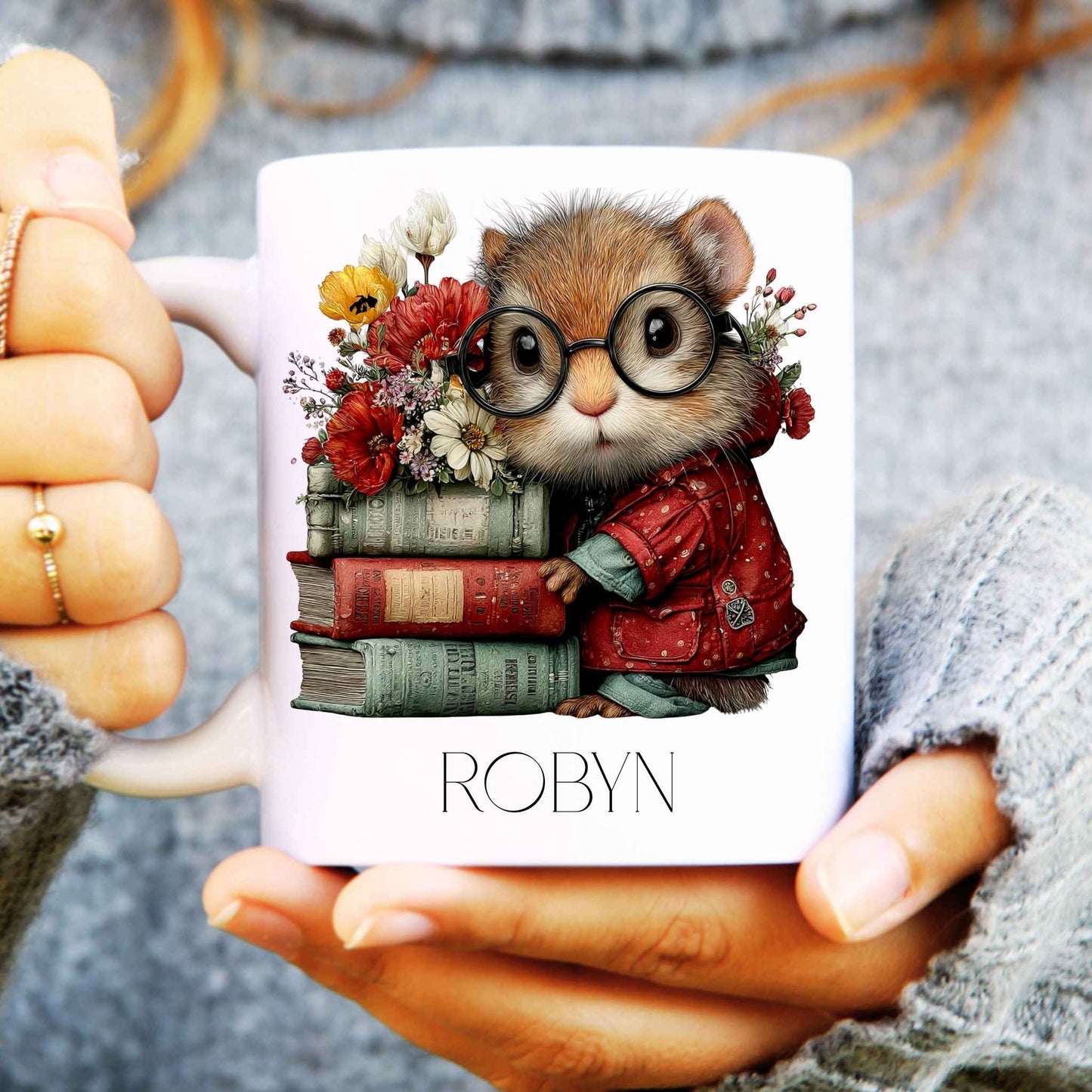 Mug with a design of a squirrel wearing glasses and holding books, held by a person.