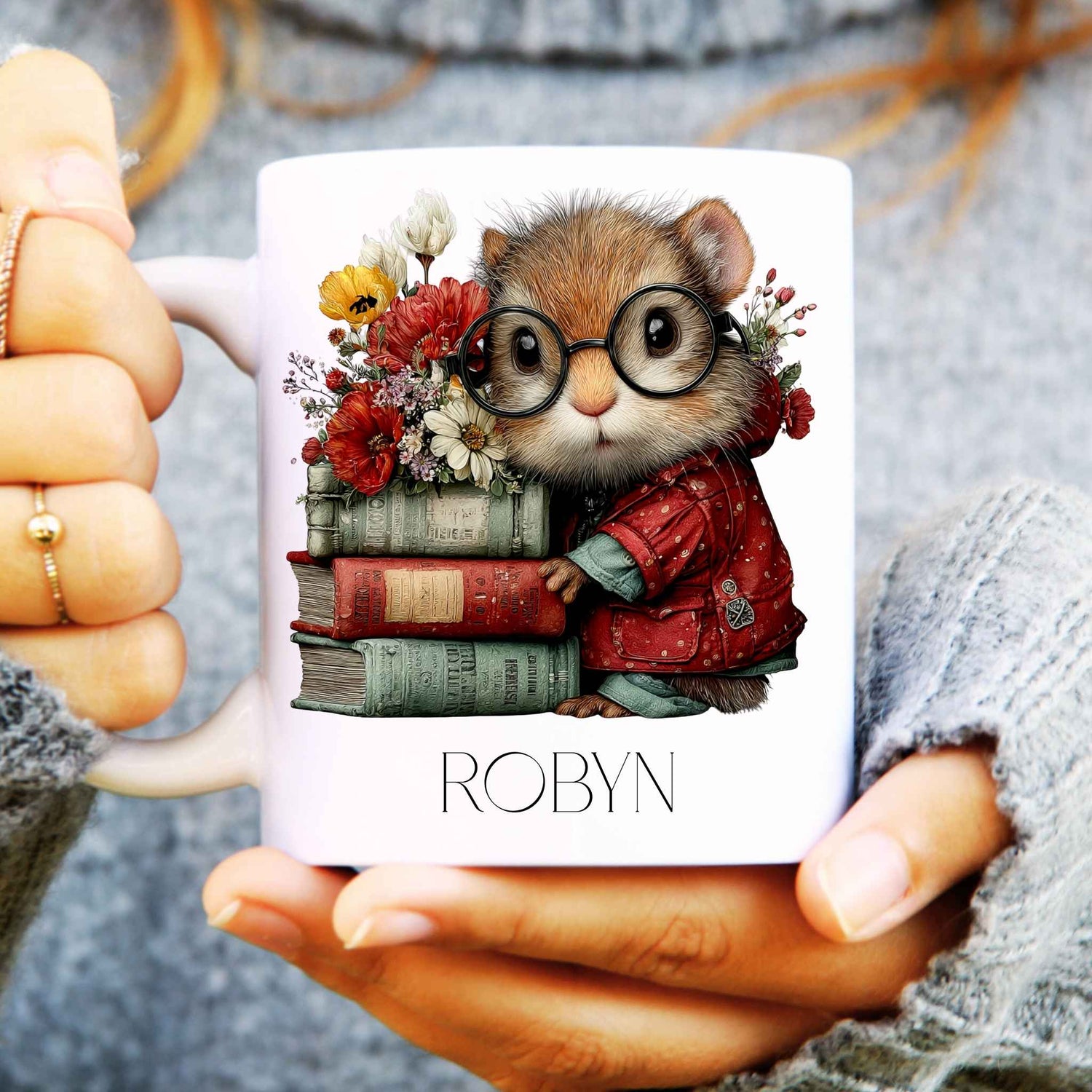 Mug with a design of a squirrel wearing glasses and holding books, held by a person.