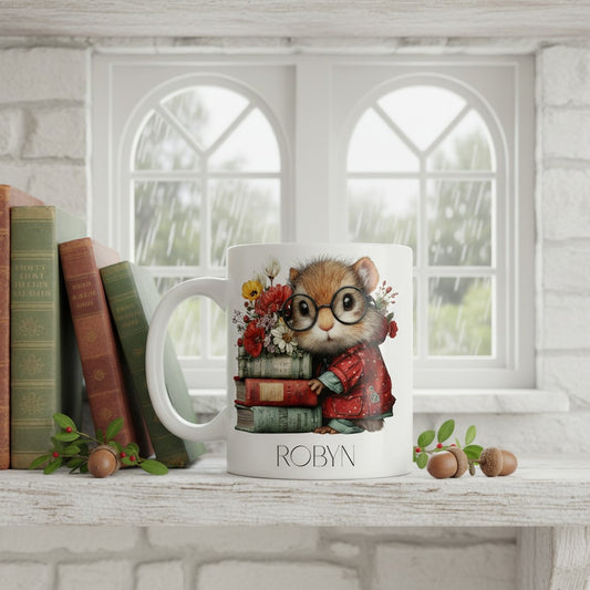 Mug with a design of a squirrel wearing glasses and reading a book, placed on a surface with books and decorative items.