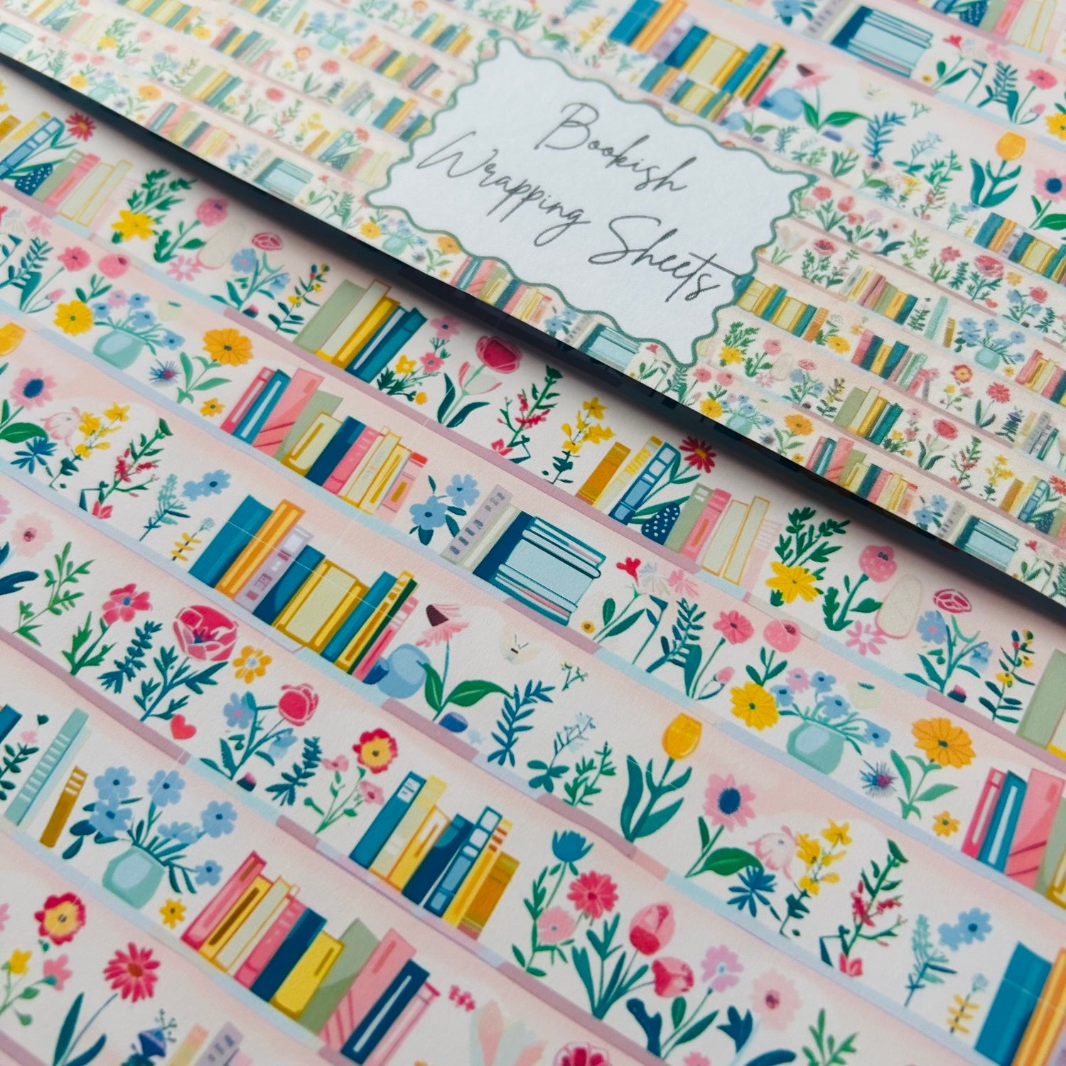 Book-themed wrapping sheets with floral designs on a white background